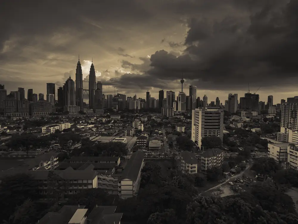 The Kuala Lumpur skyline at dusk, with the Petronas Towers